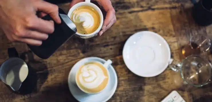 person holding teacup near saucer