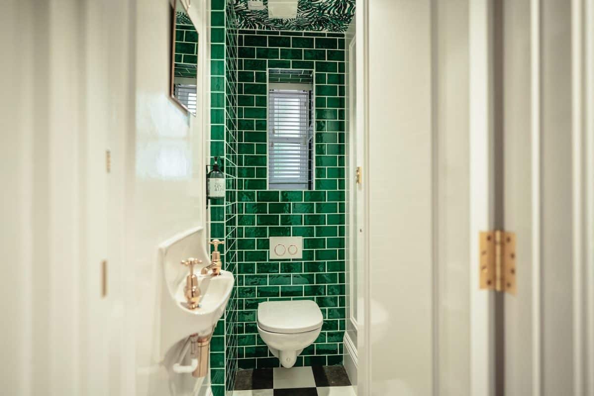 white ceramic sink near white ceramic toilet bowl